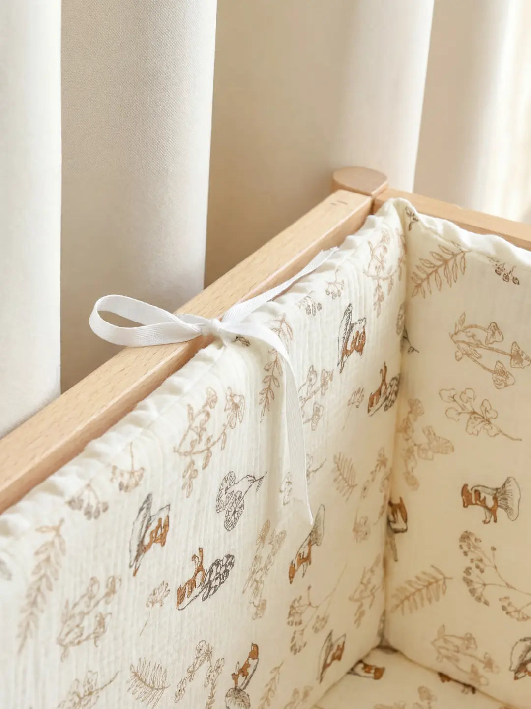 Tour de Lit Matelassé avec motifs d'animaux installé dans un berceau